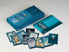 The AboraMana card set by Schiffer Publishing, Ltd. is shown with an open guidebook and vibrant self-discovery cards arranged in front of the box, featuring mystical goddess-themed artwork.
