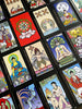 A vibrant spread of The Buddha Tarot by Schiffer Publishing, Ltd. showcases Eastern-inspired illustrations and symbolic figures on each card, including the Major Arcana, arranged neatly in rows.