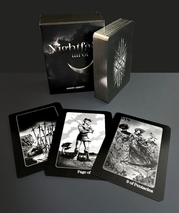 The Nightfall Tarot deck by Schiffer Publishing, Ltd. is shown with its box and three black-and-white cards—Ten of Swords, Page of Swords, and Nine of Pentacles—inspired by Rider-Waite-Smith Tarot imagery.