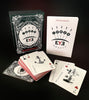 The Inner Eye Oracle by Schiffer Publishing, Ltd.—an illustrated oracle deck with symbols and keywords, spread out alongside its card box and guidebook on a black background—offers inspiration for your spiritual journey.