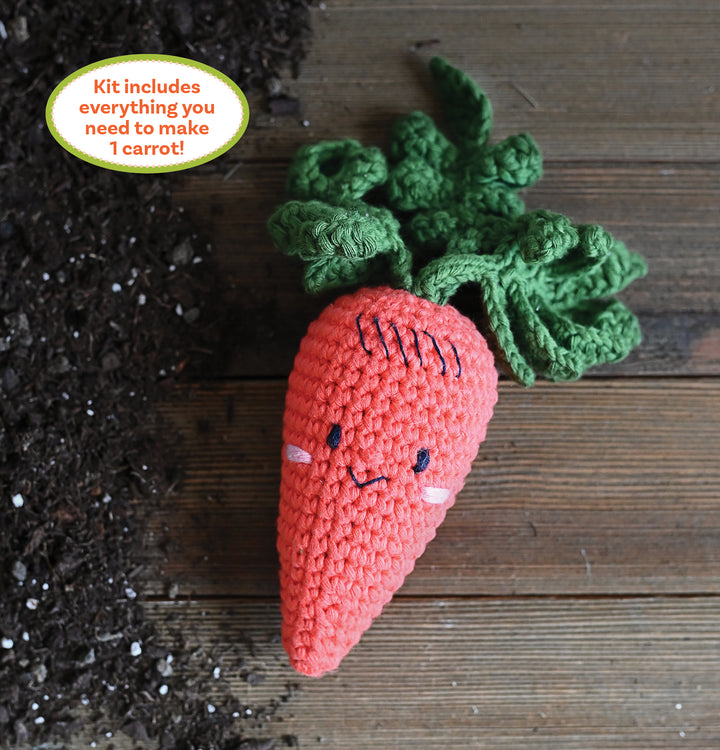 The Crochet Your Veggies Amigurumi Kit Carrot by Schiffer Publishing, Ltd. includes all you need to crochet a cute carrot with green leaves and a smiling face—perfect for beginners seeking an easy, fun crafting experience.