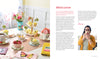 A table with cupcakes and flowers is accented by HeartFELT Crafts to Make and Give from Schiffer Publishing, Ltd., adding a charming touch of handmade decor.
